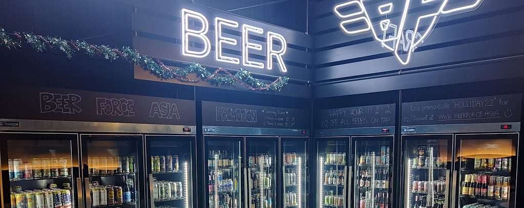 Beer Force Asia Bangkok - beer fridge corner with 100's of bottles and can of beer. 