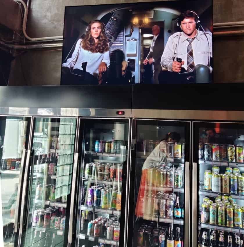 Hair of the Dog fridge wall and TV playing Airplane!