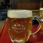 branded mug of craft beer in front of Pijiu craft beer bar in Bangkok