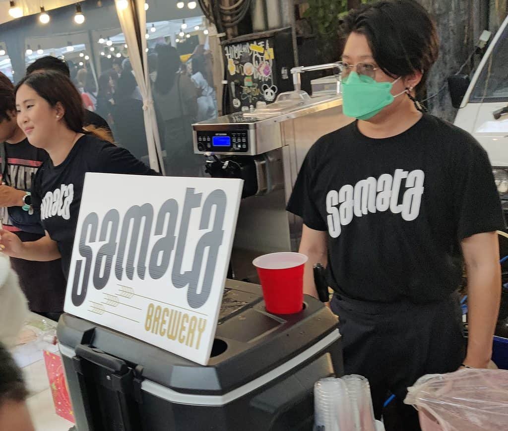 Samata Brewery booth at Beer Days craft beer fest at the Jam Factory in Bangkok. Staff wearing black Samata shirts.