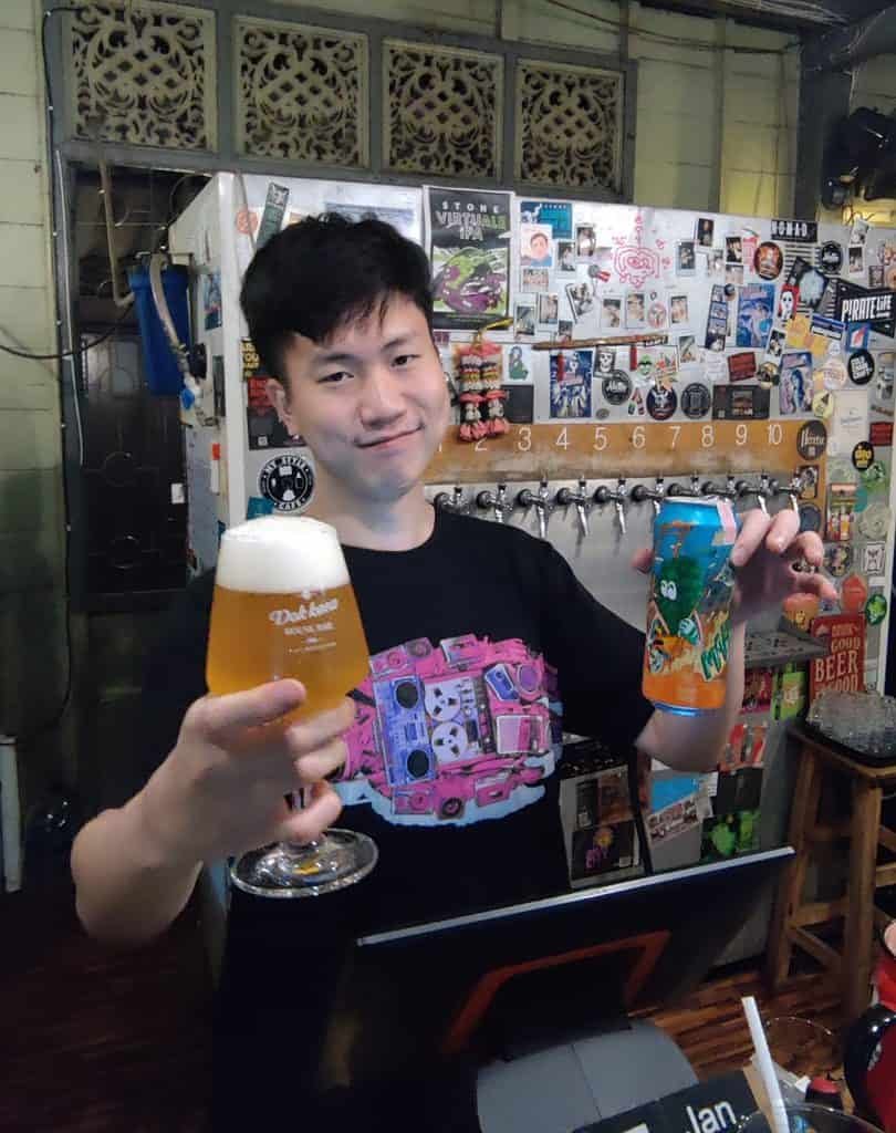 Bar man serving a craft beer at Dok Kaew House bar in Bangkok Thailand