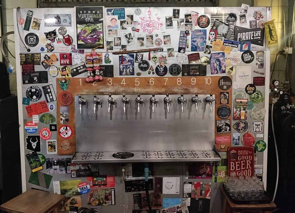 Dok Kaew house bar taps wall and fridge in Bangkok Thailand. 10 taps of mostly local Thai craft beer.