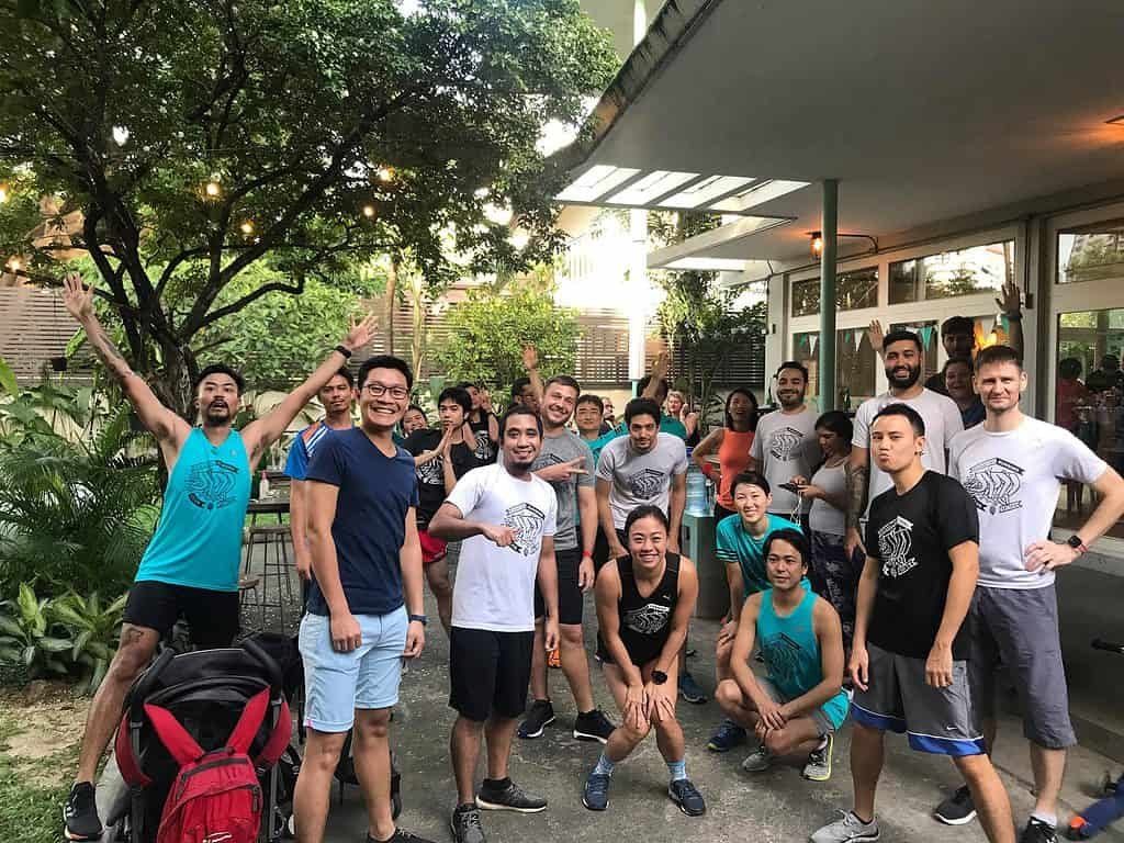 Group of runners posing outside Mikkeller Taproom in Bangkok Thailand. 