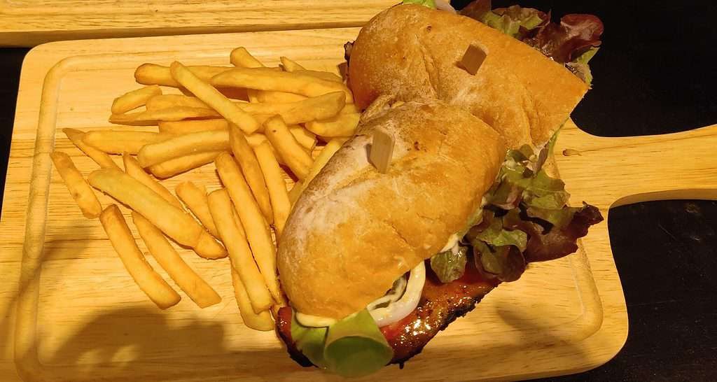 Smokehouse BBQ baguette sandwich with a side of French fries - at Billy's Smokehouse in Bangkok Thailand.