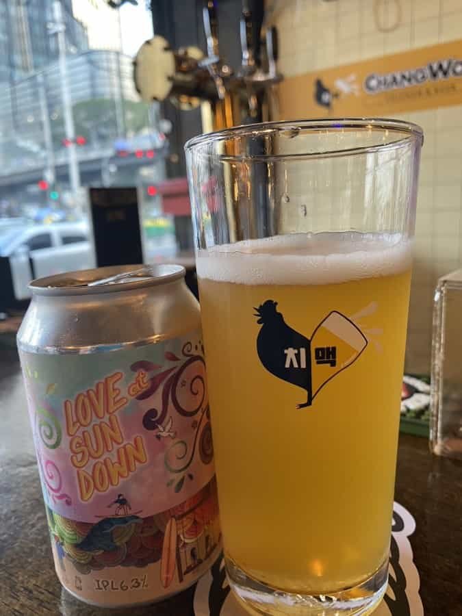 Can of Singapore craft beer served in a branded glass at Changwon Express in Bangkok Thailand