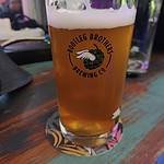 Glass of beer in a Bootleg Brothers branded glass in Bangkok Thailand