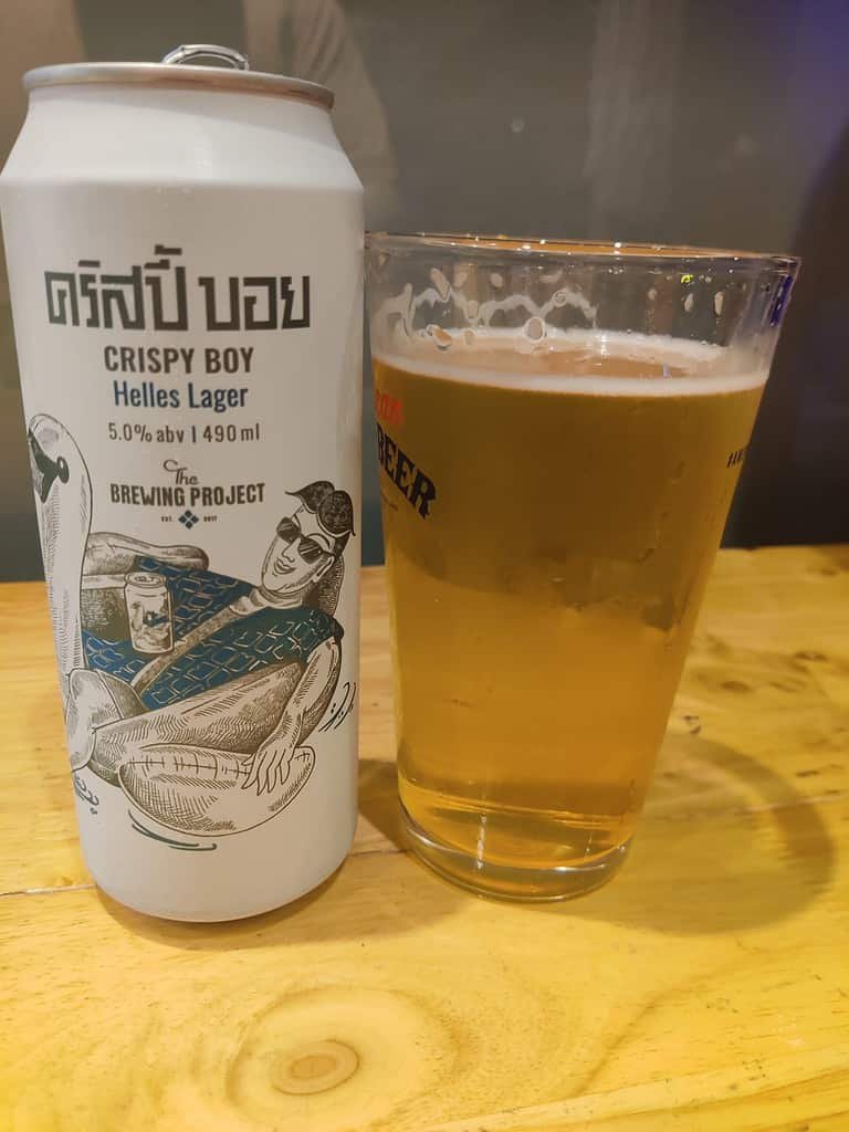 Can of Crispy Boy Helles beer brewed in Thailand The Brewing Project, Thai craft brewery; 