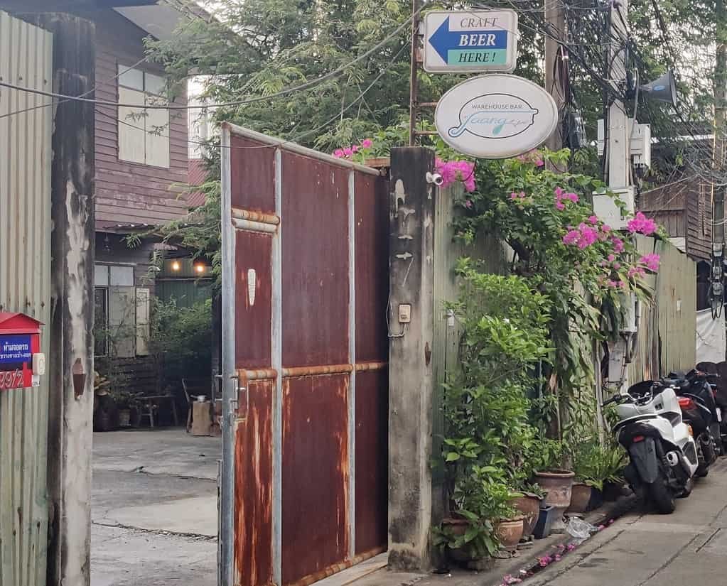 Warehouse Bar by Jaang craft beer in Bangkok Thailand. 
Picture of the gate to the patio and bar from the road. 