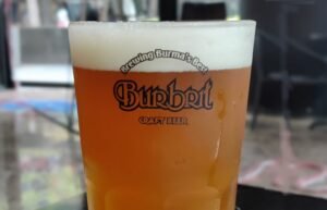 Glass of beer in a Burbrit branded glass in Bangkok Thailand