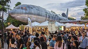 Beer Market 2 by ประชาชนเบียร์ (Beer People) at Chang Chui Creative Park in Bangkok. Large airplane above the brewery tents and beer drinking crowd in Thailand's capital.