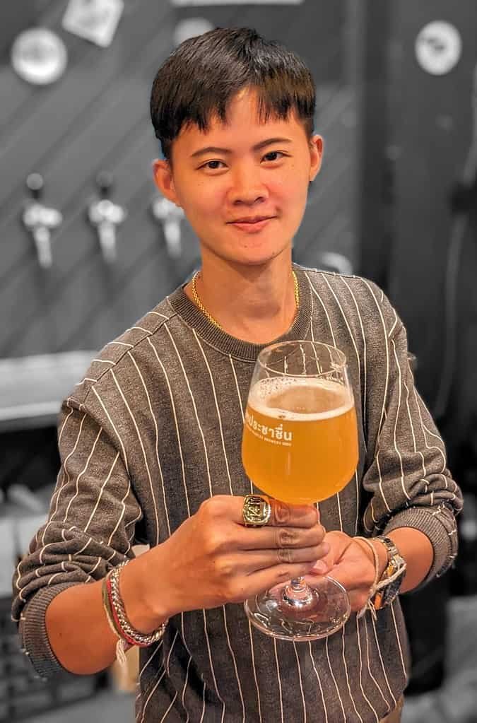 Serving a beer at Thai Craft Beer Week media event at United People's Brewery in Bangkok Thailand.