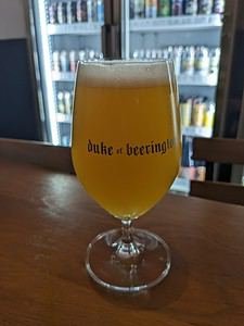 Duke of Beerington branded glass holding craft beer in Bangkok Thailand