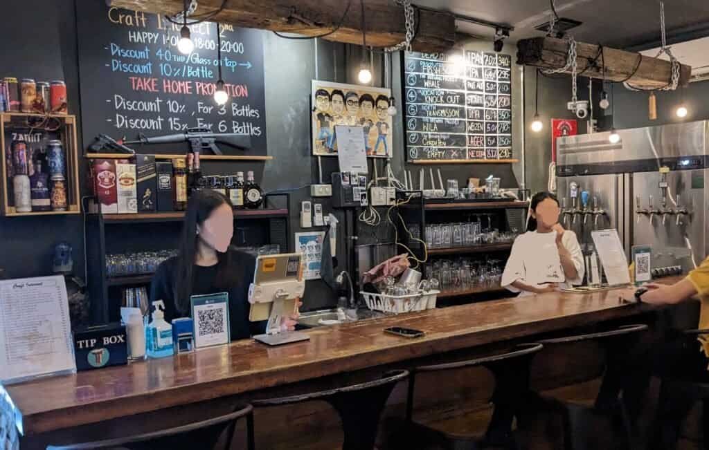 Inside and looking at the bar at Craft Intersect, serving craft beer in Bangkok Thailand. Craft beer on draft and in the fridge. 