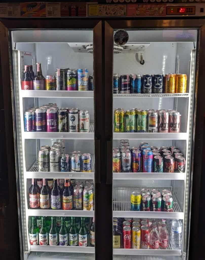 Beer Fridge of Craft Intersect craft beer bar in Bangkok Thailand, in Bang Na district.  Bottles and cans in the fridge.