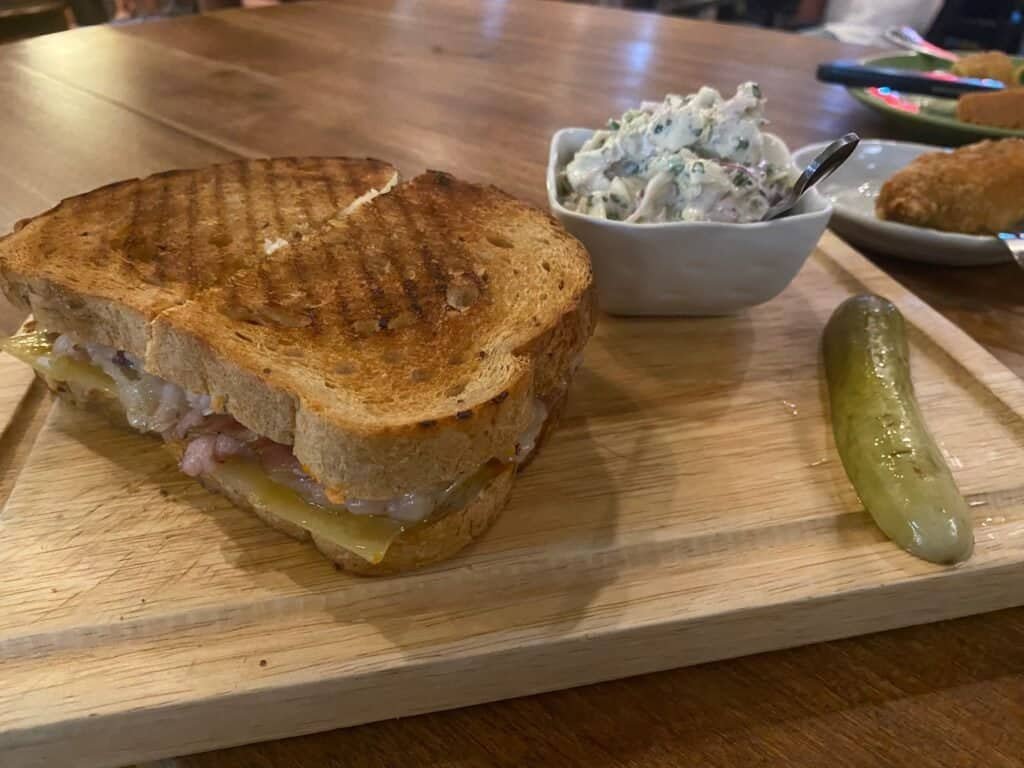 Smokehouse Reuben sandwich with a side of coleslaw and pickle - at Billy's Smokehouse in Bangkok Thailand.