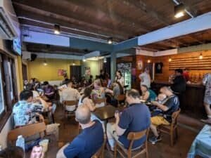 A packed house of people at Eight Days a Week Homebrew craft beer bar in Bangkok, Thailand.