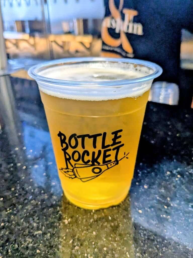 Brewsphere IPA in the cup. Held by staff at Bottle Rockets. 